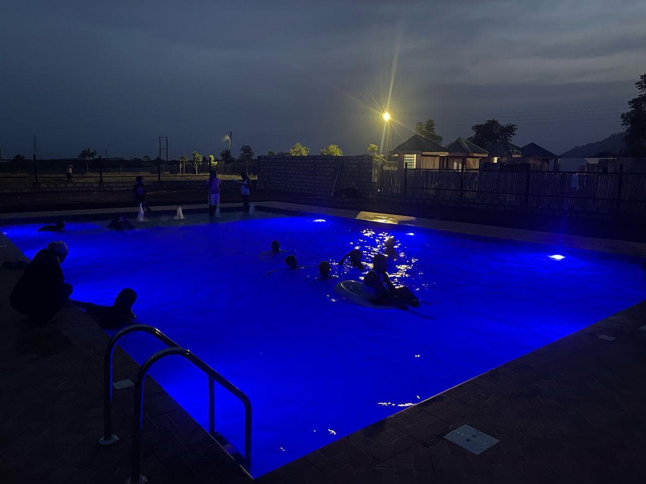 Stunning blue-lit pool at night at Hidden Paradise